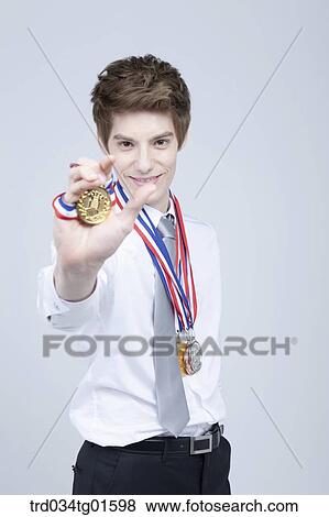 A man holding the prize medal View Large Photo Image Stock Photo - A man holding the prize medal. Fotosearch