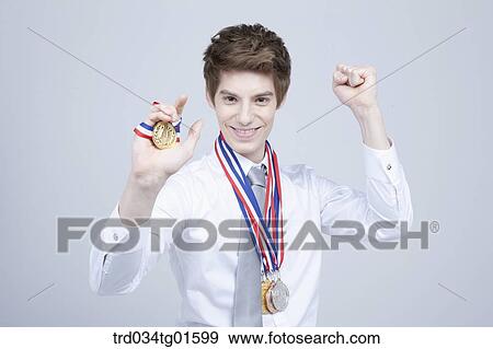A man holding the prize medal View Large Photo Image Stock Photo - A man holding the prize medal. Fotosearch