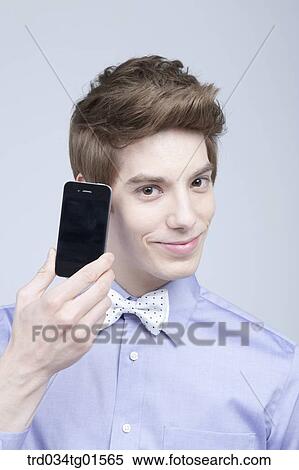 A man holding the smart phone View Large Photo Image Stock Photography - A man holding the smart phone . Fotosearch