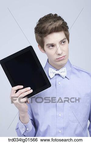 Stock Photograph - A man holding the tablet PC. Fotosearch