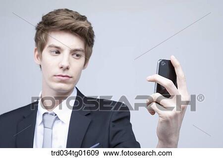 A man looking at the smart phone View Large Photo Image Stock Photo - A man looking at the smart phone. Fotosearch