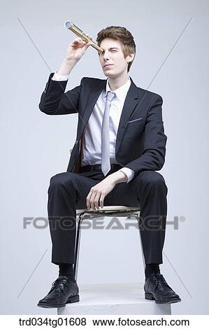 Stock Photo - A man looking through the telescope. Fotosearch
