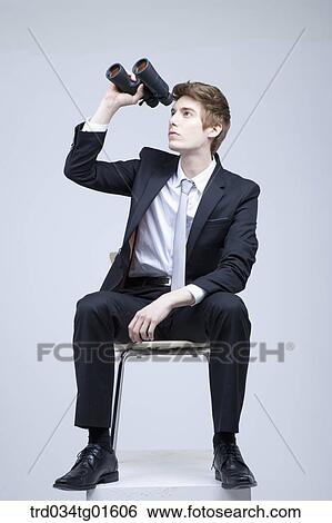Stock Photograph - A man looking through the telescope. Fotosearch