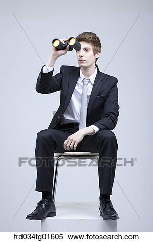 Stock Photography - A man looking through the telescope. Fotosearch