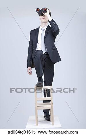 A man looking through the telescope View Large Photo Image Stock Photography - A man looking through the telescope. Fotosearch