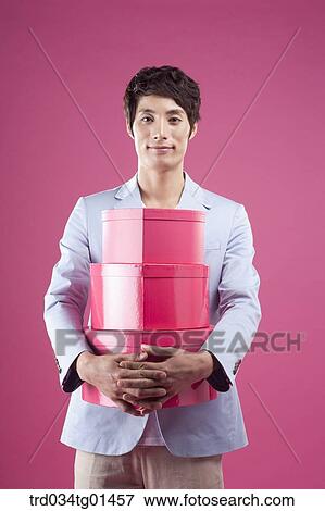 Stock Photo - A man preparing the event with gift . Fotosearch