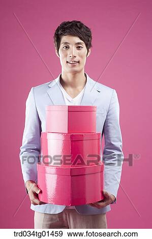 Stock Photo - A man preparing the event with gift . Fotosearch