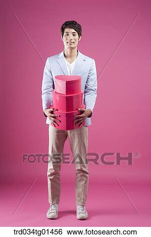 A man preparing the event with gift View Large Photo Image Stock Photograph - A man preparing the event with gift . Fotosearch