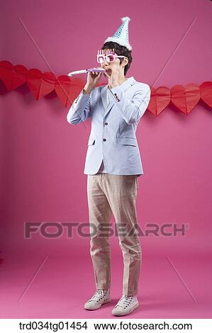 Picture - A man preparing the party event with pipe. Fotosearch