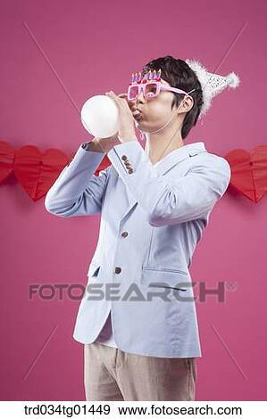 A man preparing the party event with balloon View Large Photo Image Stock Photo - A man preparing the party event with balloon. Fotosearch
