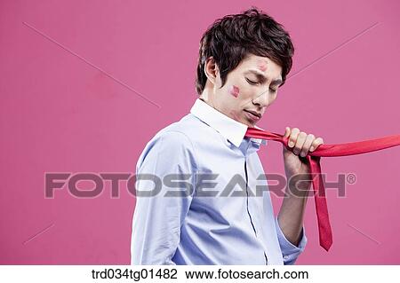 Stock Image - A man pulled with his red tie. Fotosearch