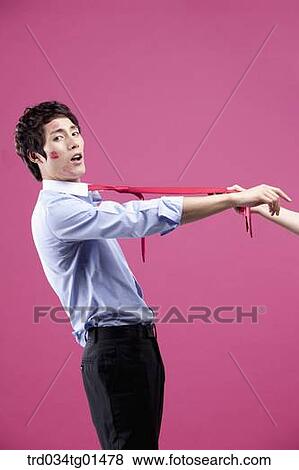 A man pulled with his red tie View Large Photo Image Stock Photo - A man pulled with his red tie. Fotosearch