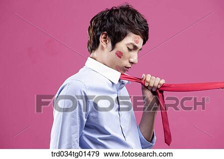 Stock Photo - A man pulled with his red tie. Fotosearch