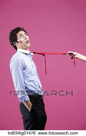 A man pulled with his red tie View Large Photo Image Stock Photograph - A man pulled with his red tie. Fotosearch