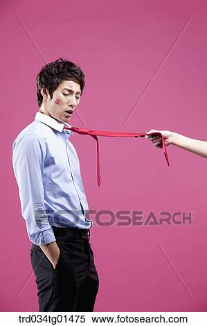 Stock Photography - A man pulled with his red tie. Fotosearch