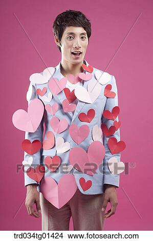 Picture - A man putting heart on the body. Fotosearch