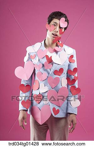 Stock Photo - A man putting heart on the body. Fotosearch