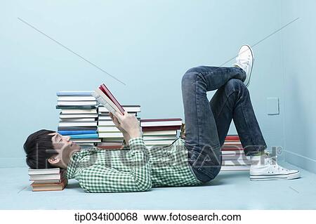 Stock Photo - A man reading a book on the floor. Fotosearch