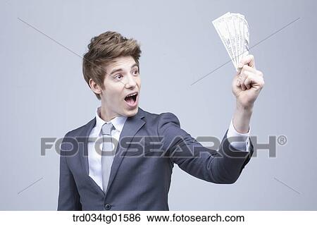 A man surprised at the money View Large Photo Image Stock Photograph - A man surprised at the money. Fotosearch