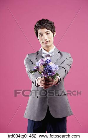 A man wearing formal suit with the flower View Large Photo Image Stock Image - A man wearing formal suit with the flower. Fotosearch