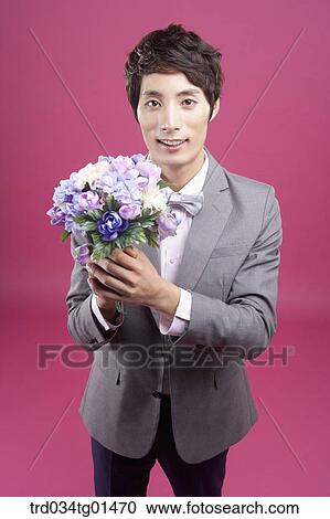 A man wearing formal suit with the flower View Large Photo Image Stock Image - A man wearing formal suit with the flower. Fotosearch