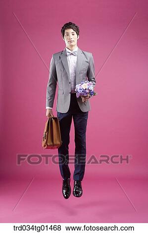 A man wearing formal suit with the flower and bag View Large Photo Image Stock Photo - A man wearing formal suit with the flower and bag. Fotosearch