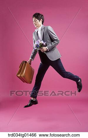 A man wearing formal suit with the flower and bag View Large Photo Image Stock Photograph - A man wearing formal suit with the flower and bag. Fotosearch