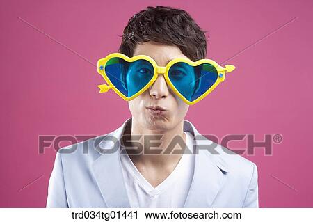 A man wearing the heart shaped glasses View Large Photo Image Stock Image - A man wearing the heart shaped glasses. Fotosearch