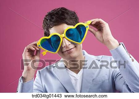 A man wearing the heart shaped glasses View Large Photo Image Stock Image - A man wearing the heart shaped glasses. Fotosearch