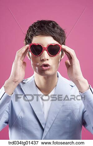 A man wearing the heart shaped glasses View Large Photo Image Stock Photo - A man wearing the heart shaped glasses. Fotosearch