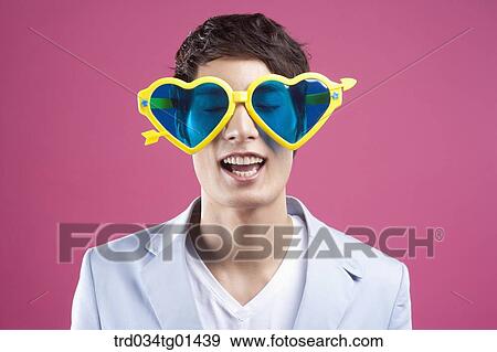 A man wearing the heart shaped glasses View Large Photo Image Stock Photo - A man wearing the heart shaped glasses. Fotosearch