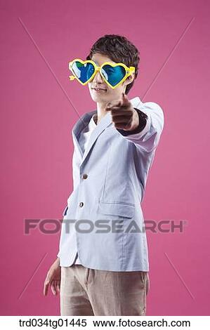 A man wearing the heart shaped glasses with pointing finger View Large Photo Image Stock Photography - A man wearing the heart shaped glasses with pointing finger. Fotosearch