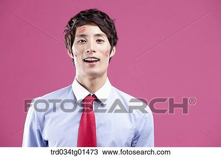 A man with red lip print on his cheeks View Large Photo Image Stock Image - A man with red lip print on his cheeks. Fotosearch