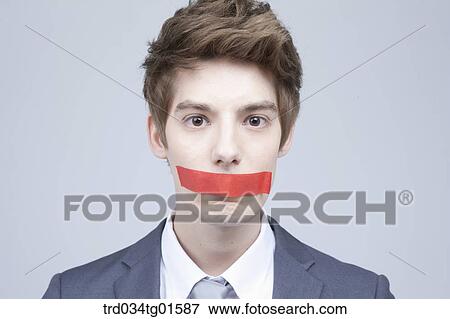 A man with red tape on his mouth View Large Photo Image Stock Photo - A man with red tape on his mouth. Fotosearch