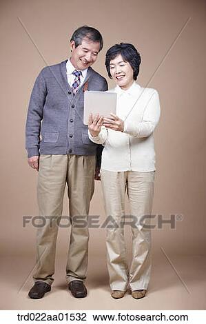 A old man and old woman looking at tablet PC View Large Photo Image Stock Image - A old man and old woman looking at tablet PC. Fotosearch