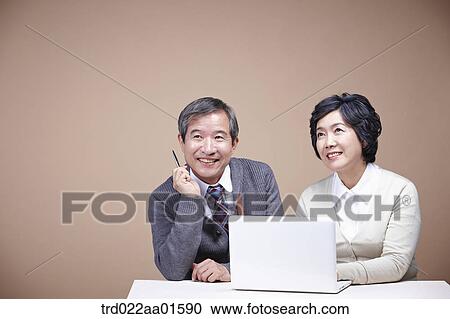 A smiling old man and old woman with laptop View Large Photo Image Stock Image - A smiling old man and old woman with laptop. Fotosearch