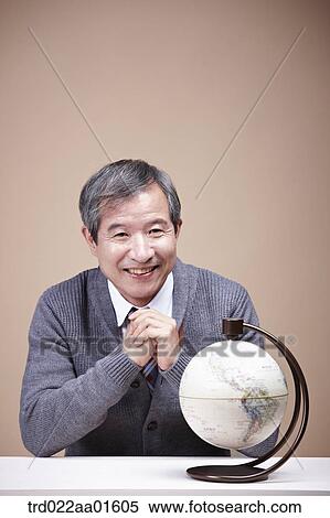 Stock Photography - A smiling old man with globe. Fotosearch