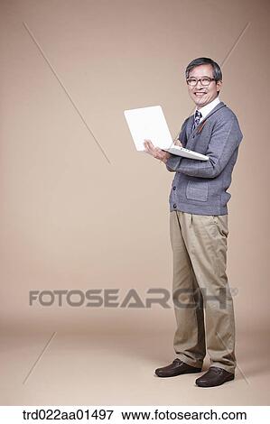 A smiling old man with laptop View Large Photo Image Stock Photo - A smiling old man with laptop. Fotosearch