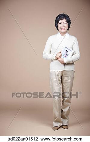 A smiling old woman with family photograph View Large Photo Image Stock Image - A smiling old woman with family photograph. Fotosearch