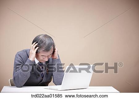 Stock Photography - A stressful old man with laptop . Fotosearch