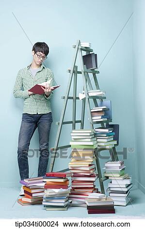 A studying man by the piled books and ladder View Large Photo Image Picture - A studying man by the piled books and ladder. Fotosearch