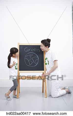 Stock Photo - A woman and girl with green globe painting . Fotosearch