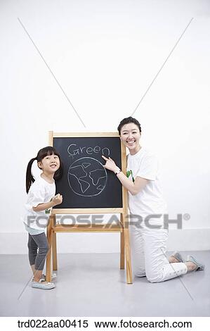 Stock Photography - A woman and girl with green globe painting . Fotosearch