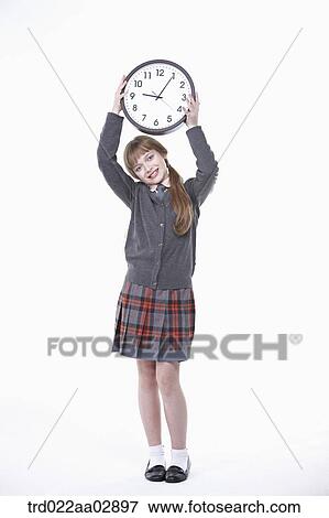Stock Photo - An American student holding up the clock. Fotosearch
