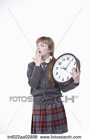 An American student yawning with clock View Large Photo Image Stock Photo - An American student yawning with clock. Fotosearch