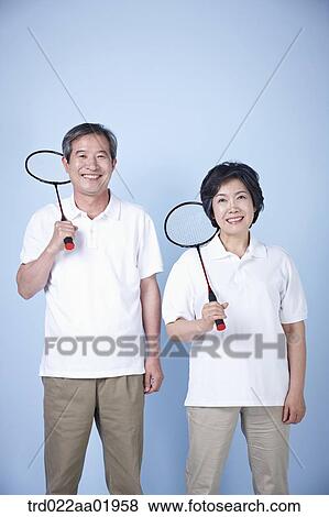 Stock Photo - An old couple with badminton racket. Fotosearch