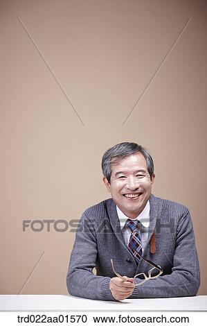 An old man holding the glasses View Large Photo Image Stock Image - An old man holding the glasses. Fotosearch