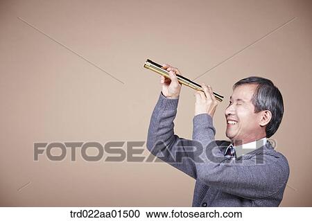 An old man looking through telescope View Large Photo Image Stock Image - An old man looking through telescope. Fotosearch