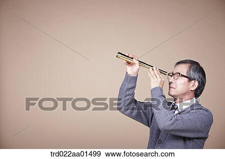 An old man looking through telescope View Large Photo Image Stock Photo - An old man looking through telescope. Fotosearch