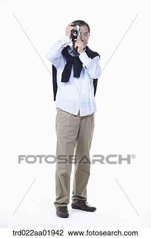 An old man photographing with camera View Large Photo Image Stock Image - An old man photographing with camera. Fotosearch